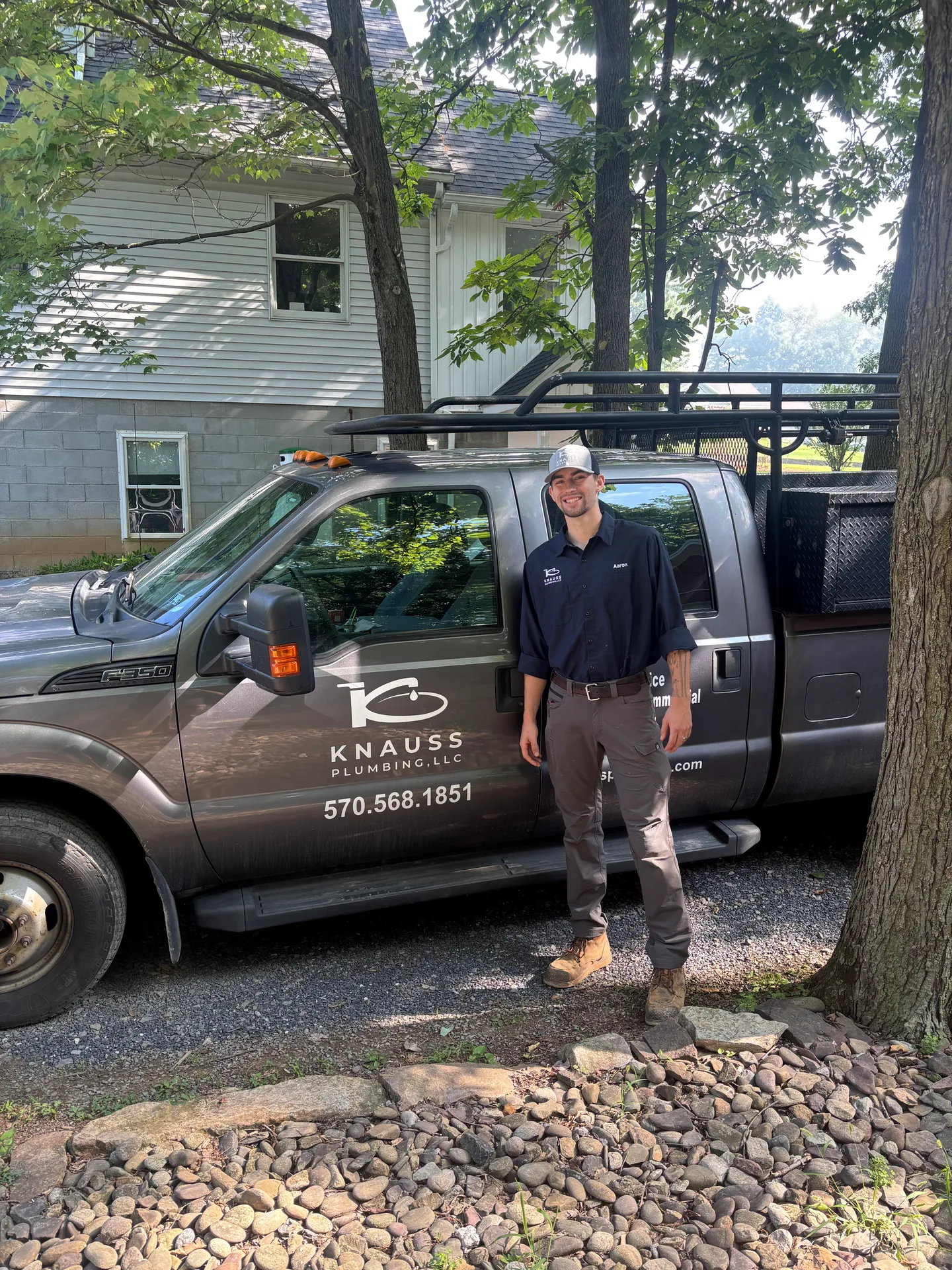 Knauss Plumbing Owner With Service Van Knauss Plumbing owner standing beside the Knauss Plumbing service van.